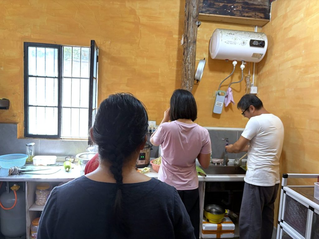 分工自然的厨房现场:有人在水槽前,有人在灶台边,各在其位。